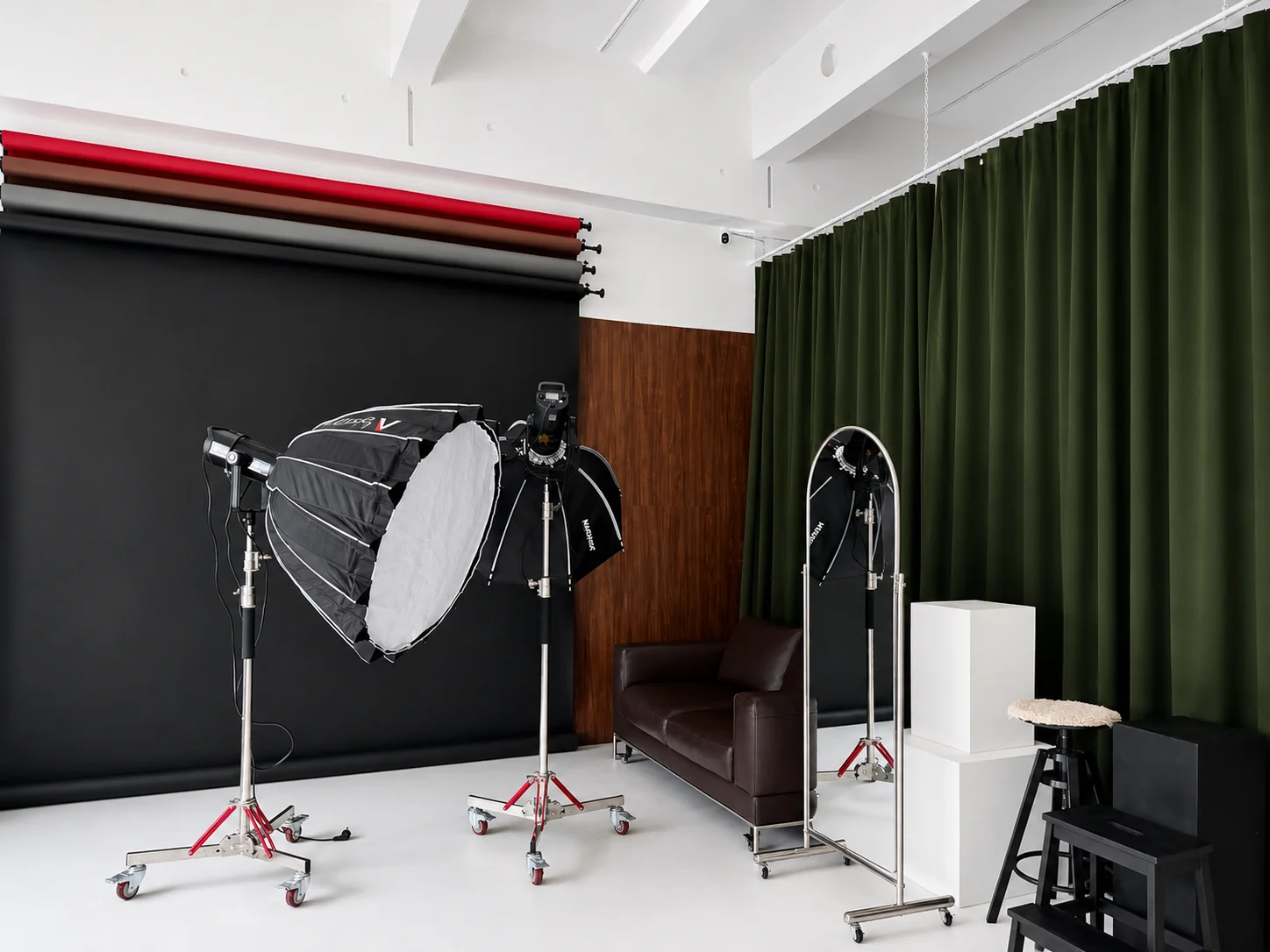 Aesthetic Space München: Fotostudio mit Studioblitzen, Hintergrundrollen, grünen Vorhängen und Designermöbeln